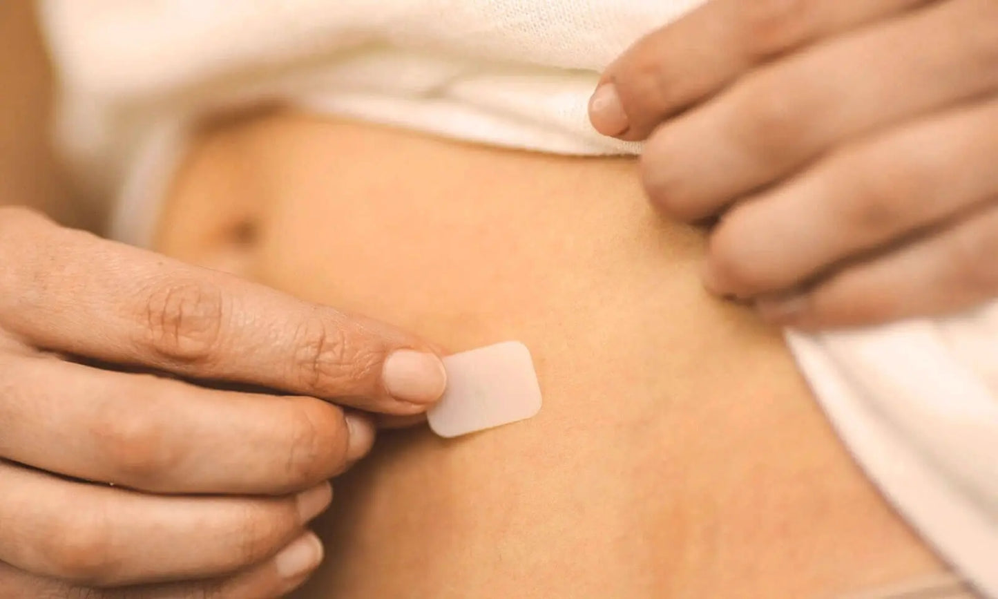 a woman applying an estrogen patch