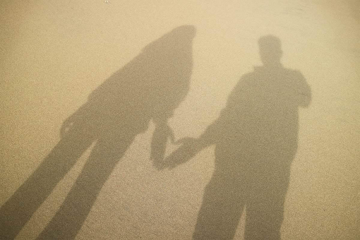 image of shadow showing two people by the beach