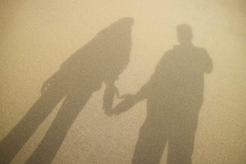 image of shadow showing two people by the beach