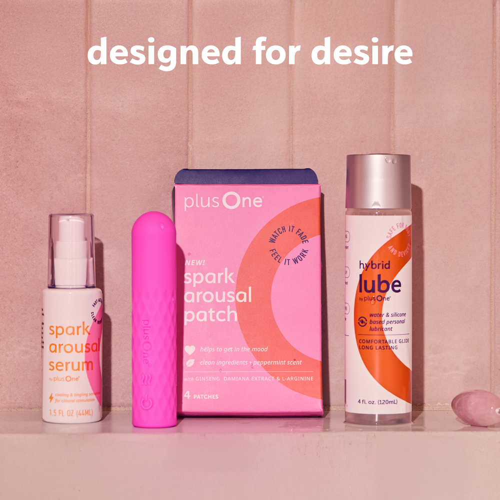 
                  
                    Collection of personal care products including a serum, patch, and lubricant on a pink background with 'plusOne' branding.
                  
                