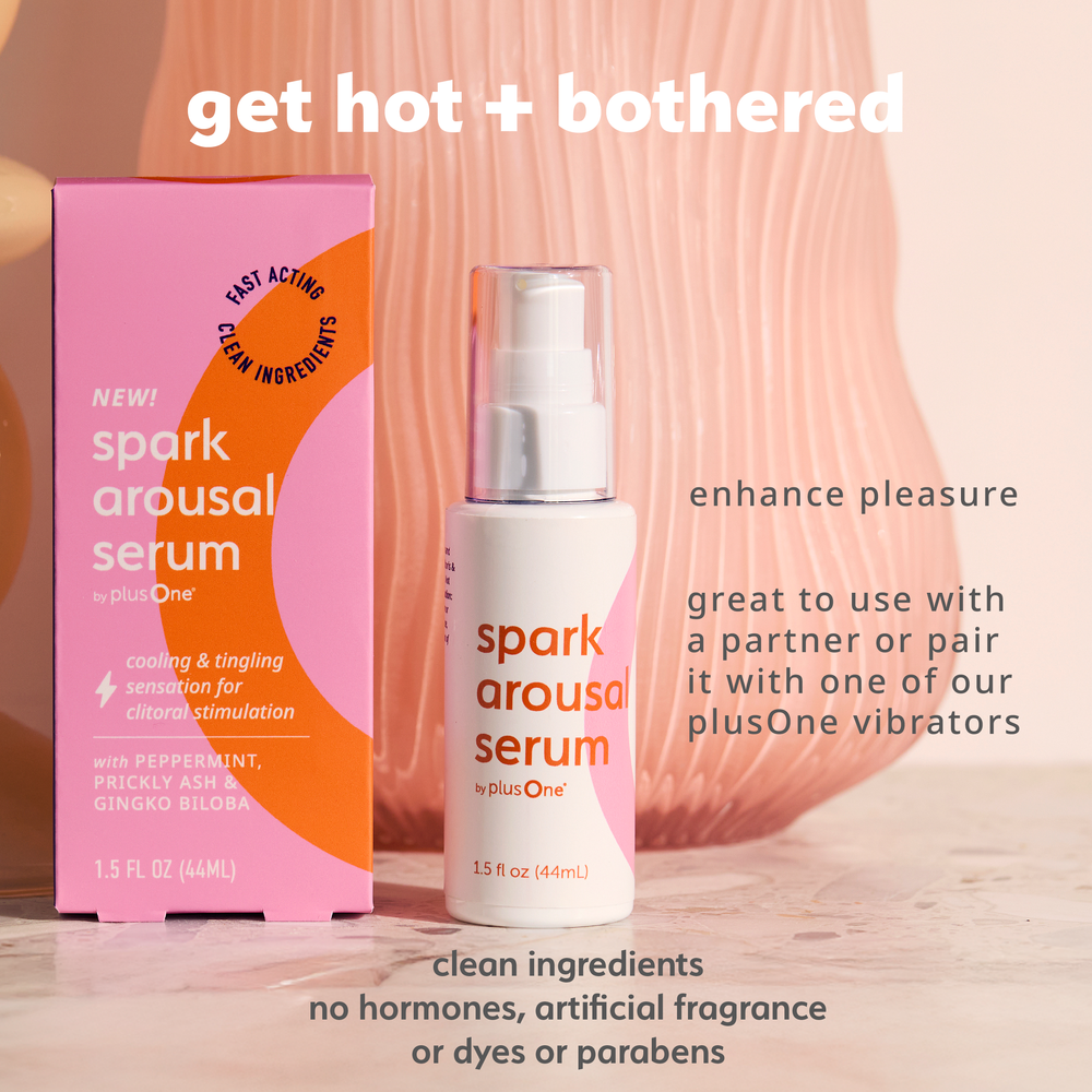 Spark arousal serum packaging with pink and orange design on a wooden surface.