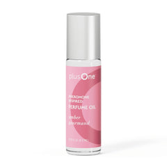 Perfume oil bottle with pink label and silver cap on a white background