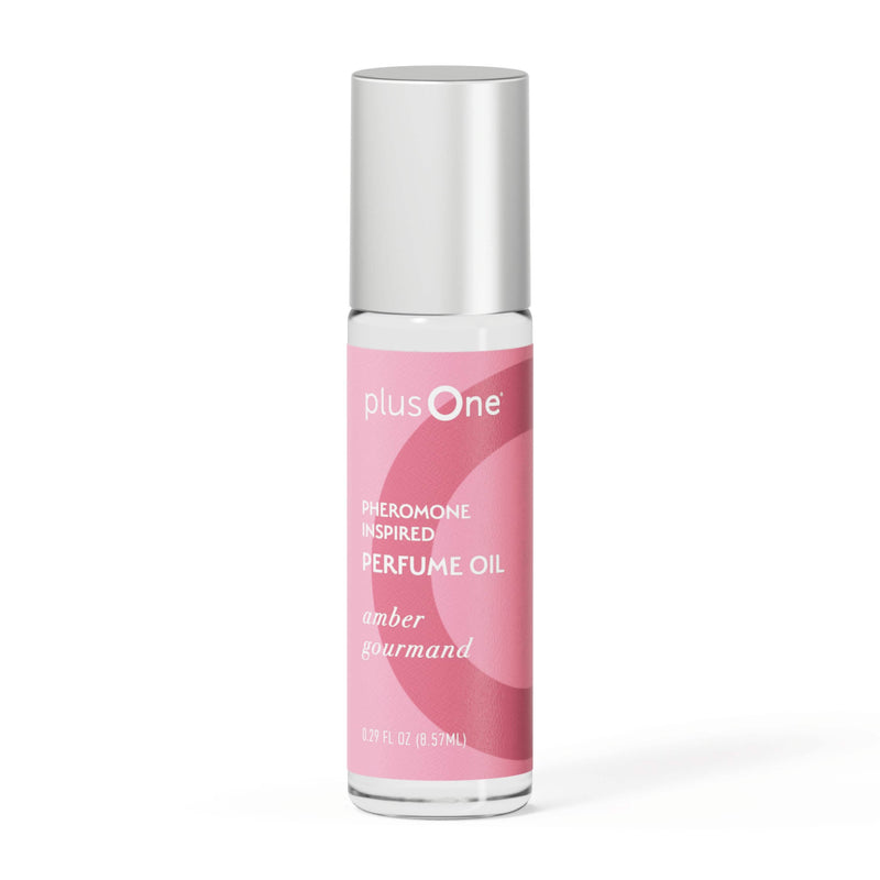 Perfume oil bottle with pink label and silver cap on a white background