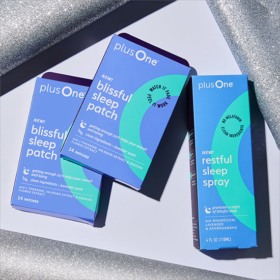Two boxes of plusOne blissful sleep patch and restful sleep spray on a reflective surface.